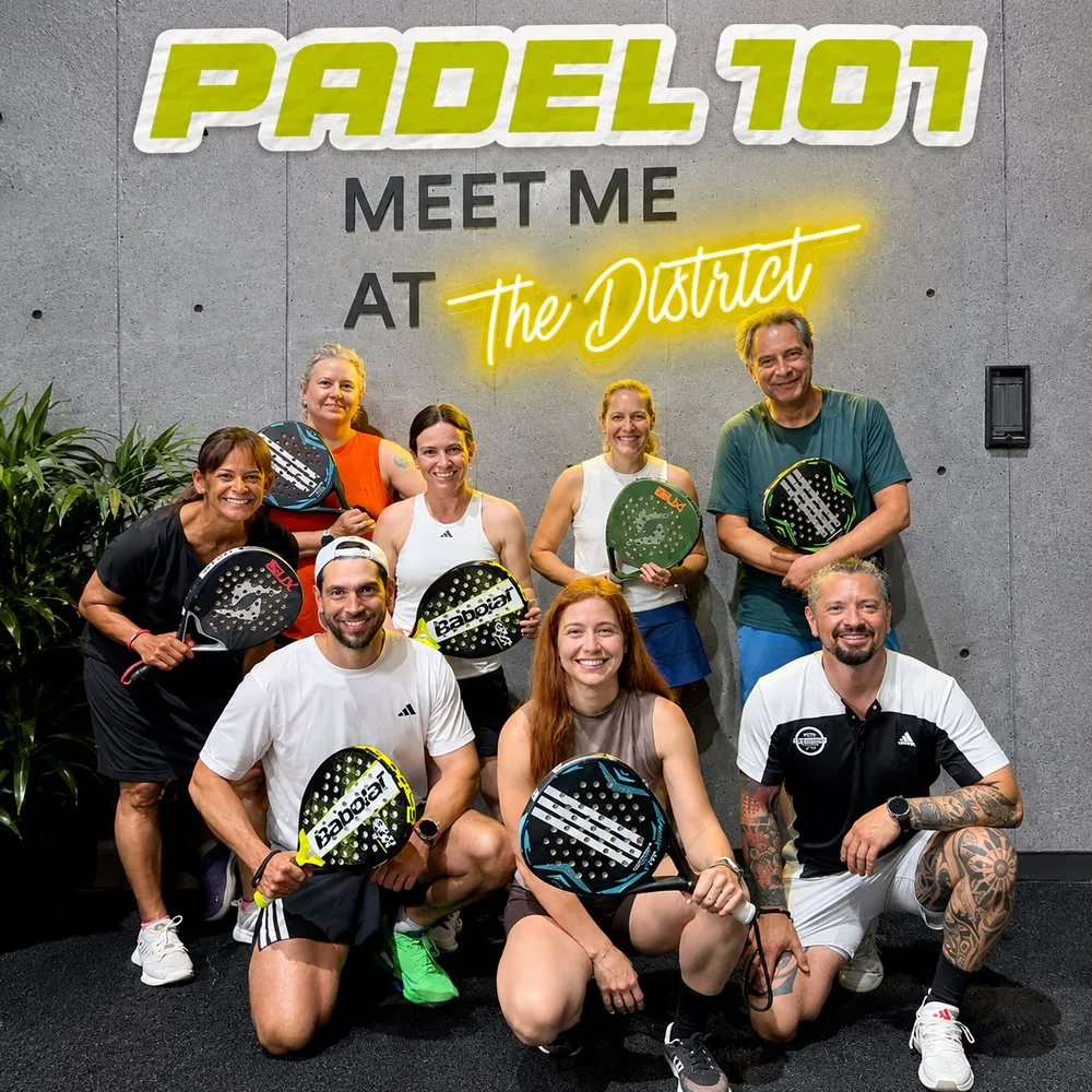 Padel 101 beginner intro session at The District with a group of new players holding padel rackets
