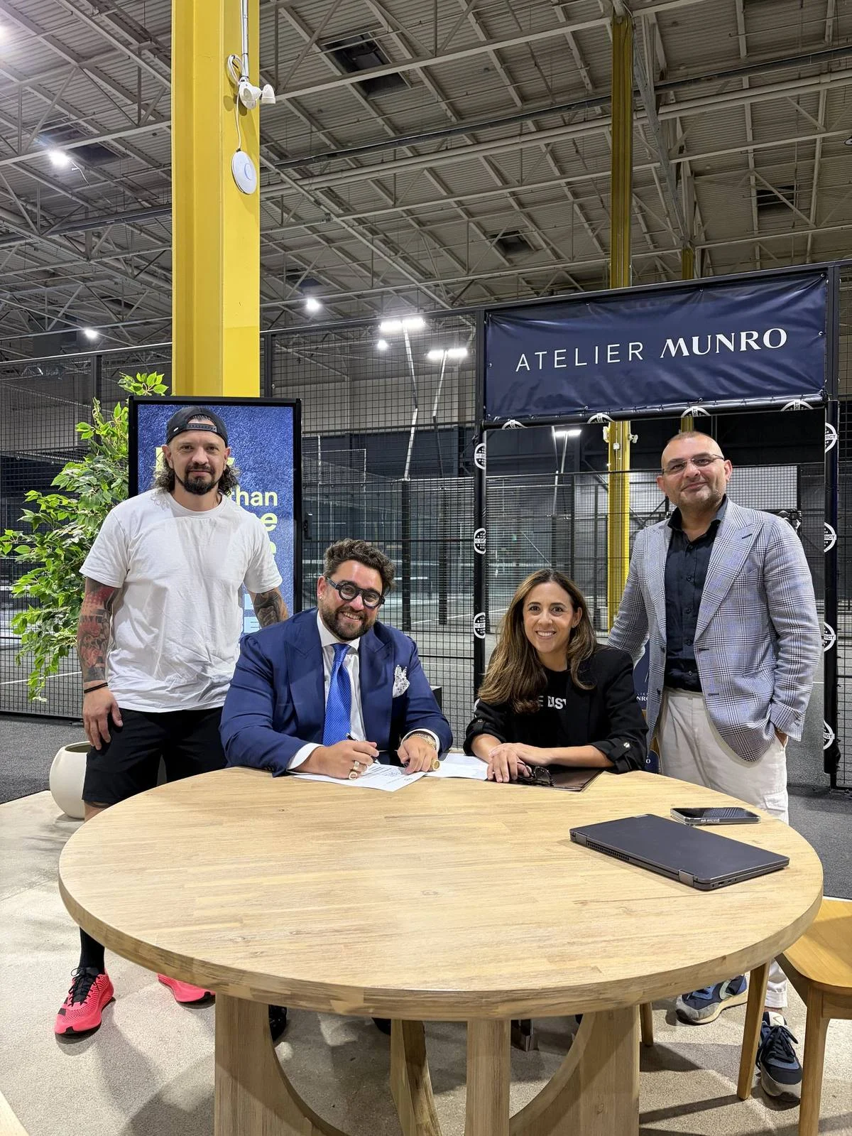 Daniela Varas signing the Atelier Munro partnership agreement
