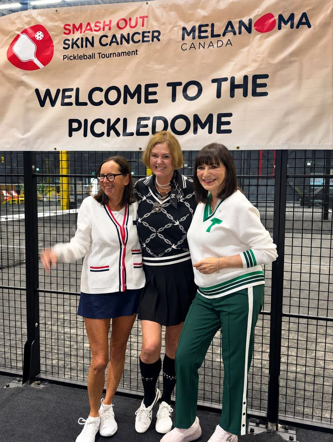 Jeanne Beker with two guests under the Welcome to the Pickledome banner at The District