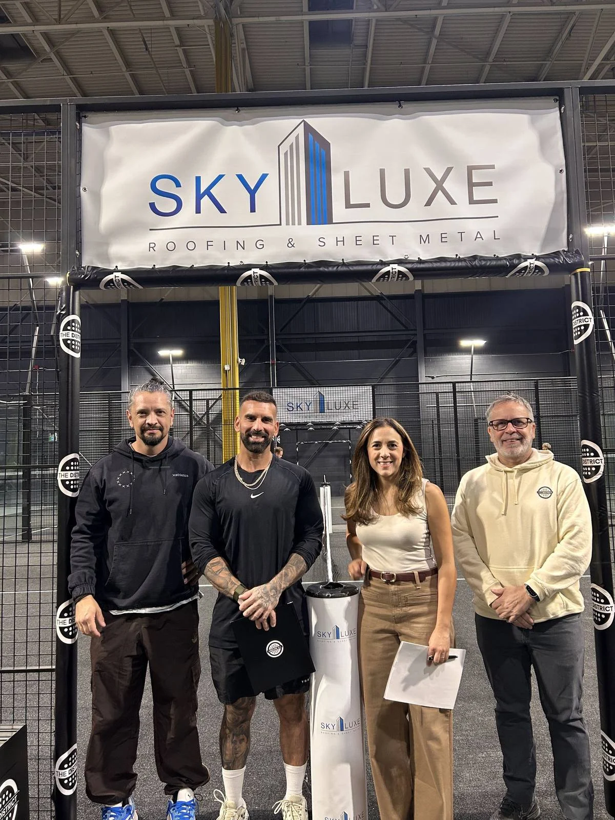 The District team with Sky Luxe Roofing & Sheet Metal under the partnership banner
